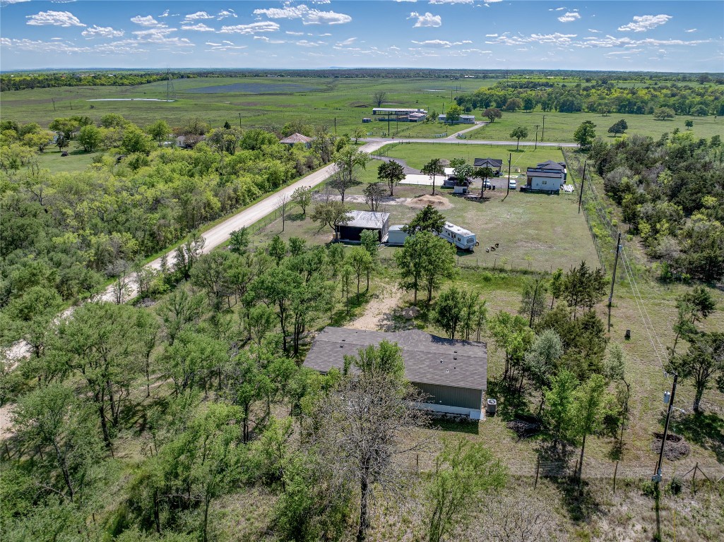 145 Crooked Road Dale, TX 78616 - Photo 20 of 26 an aerial view of a house with a garden and lake view