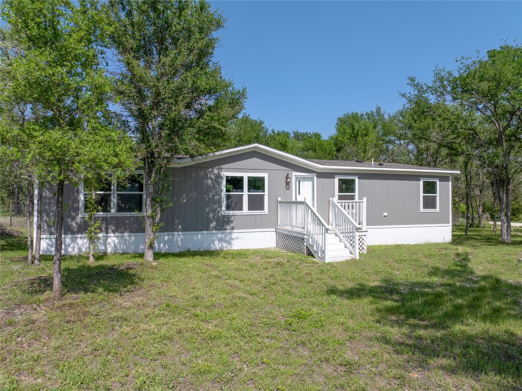 145 Crooked Road Dale, TX 78616 - Photo 3 of 26 a house that has a big yard with large trees