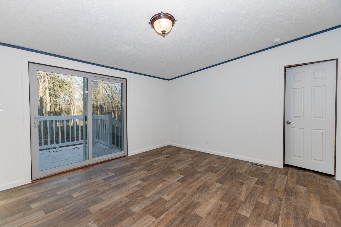 145 Crooked Road Dale, TX 78616 - Photo 8 of 26 a view of a room with wooden floor and windows