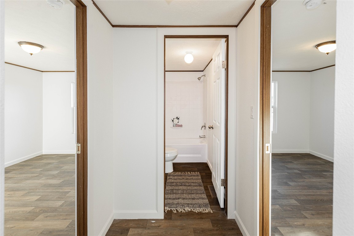 145 Crooked Road Dale, TX 78616 - Photo 9 of 26 a view of a hallway with wooden floor and staircase