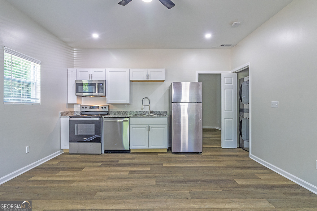 5971 Bloomfield Road Macon, GA 31206 - Photo 6 of 19 a kitchen with a refrigerator and a stove top oven