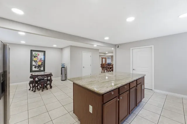 a room with a sink a table and chairs