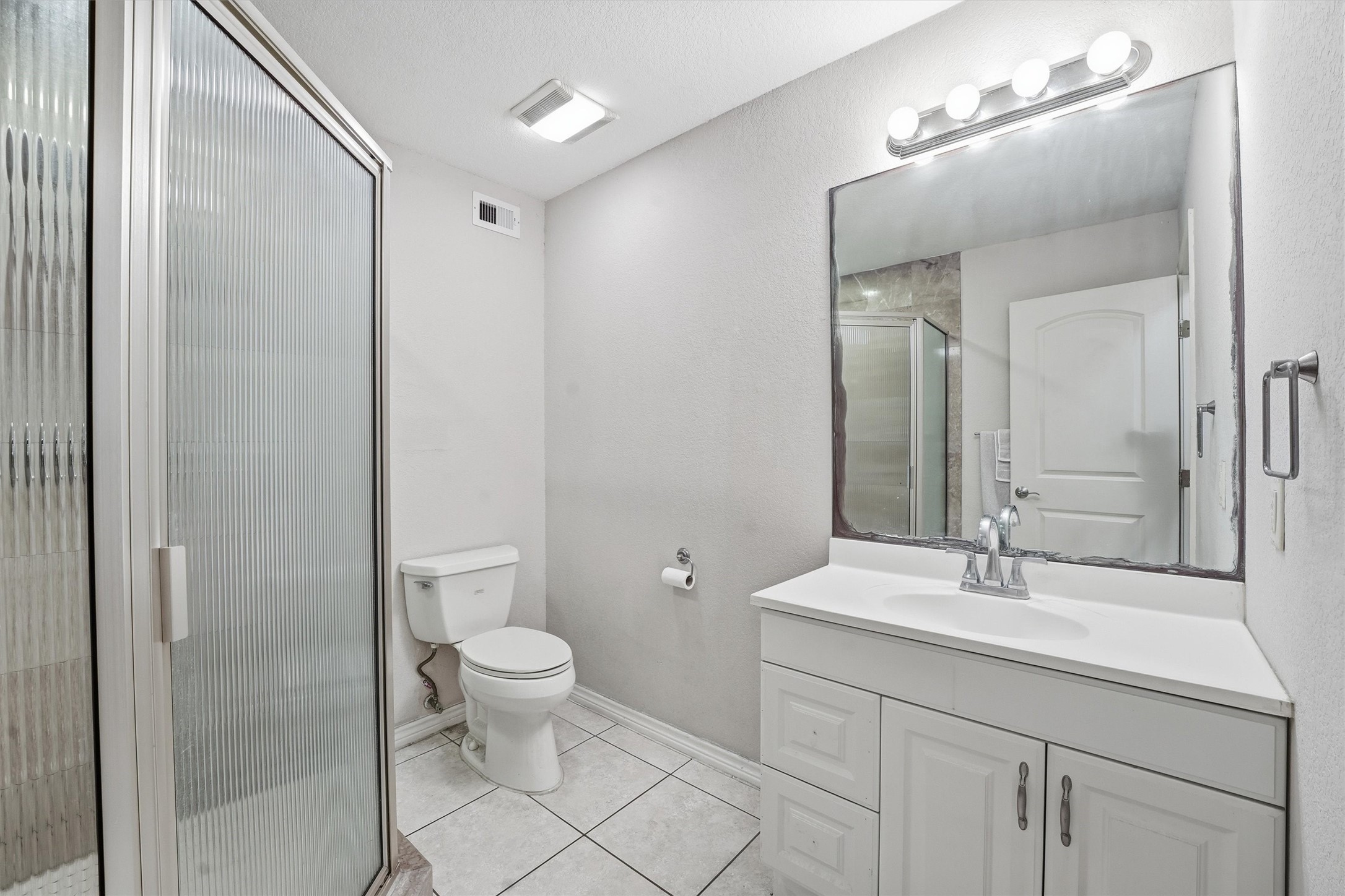 3227 Audley Street Houston, TX 77098 - Photo 22 of 30 a bathroom with a toilet a sink and mirror