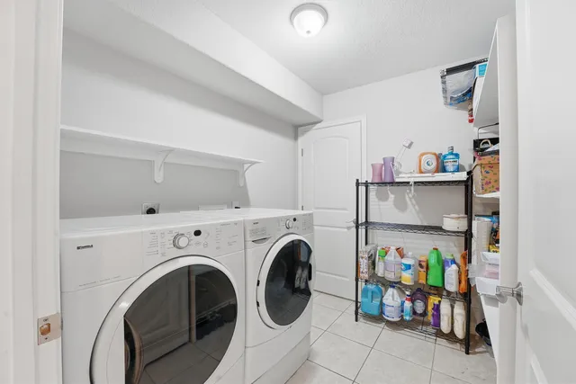 a view of storage and utility room with washer and dryer