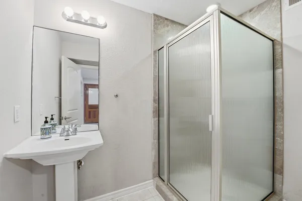 a bathroom with a sink and mirror