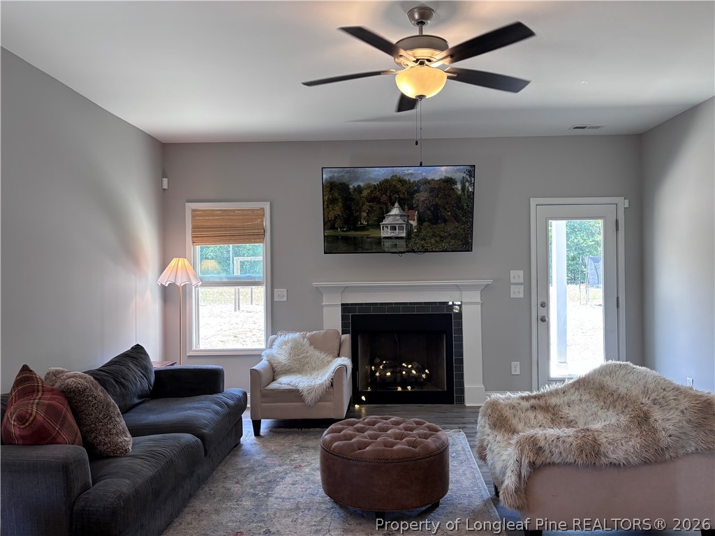 7720 Rufus Johnson Road Fayetteville, NC 28306 - Photo 31 of 50 a living room with furniture and a fireplace