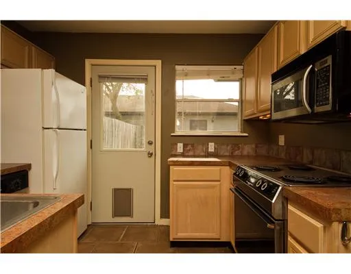 a kitchen with a stove a refrigerator and a sink