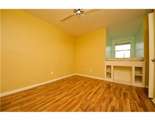 a view of an empty room and wooden floor