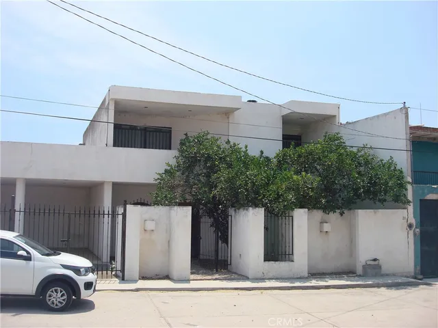 a front view of a house with parking space