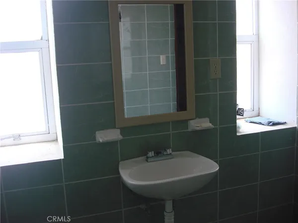 a bedroom with a bed and a dresser in it