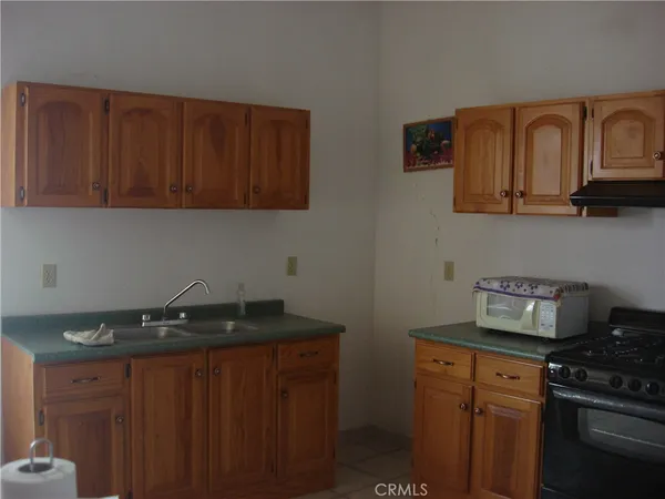 a kitchen with granite countertop stainless steel appliances a stove a sink and dishwasher