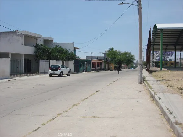 a view of building with car parked