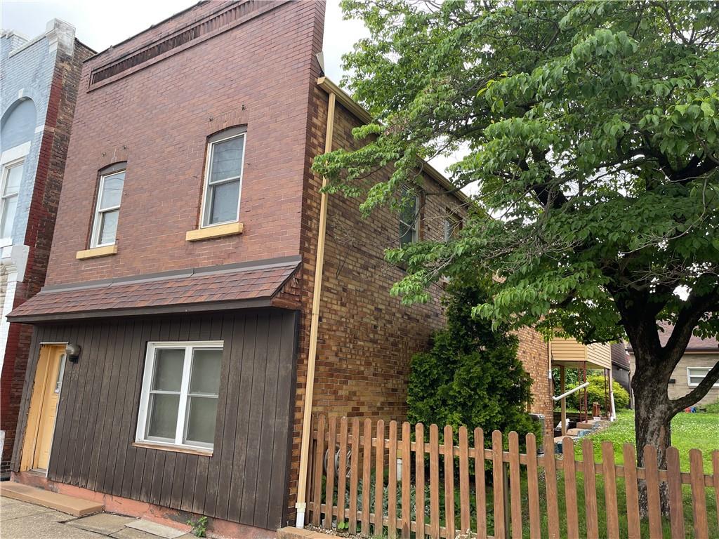 a front view of a house with tree s