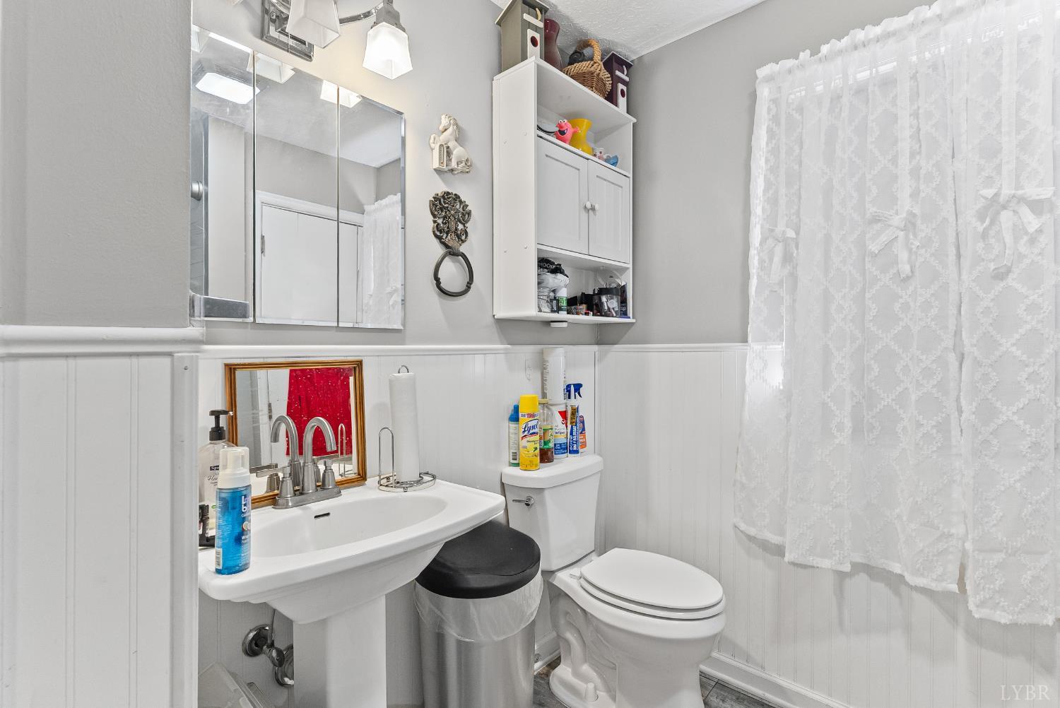473 Forest Sale Road Amherst, VA 24521 - Photo 11 of 39 a bathroom with a sink a toilet and a shower curtain