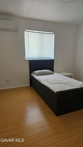 a bedroom with a bed and window