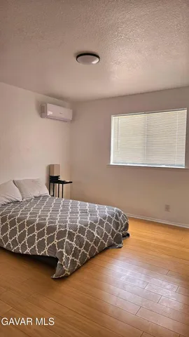 a bedroom with double bed and a large window