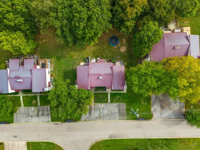 an aerial view of a house with yard