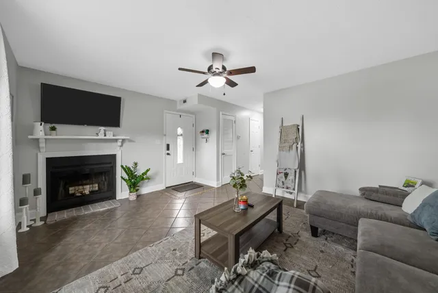 a living room with furniture a flat screen tv and a fireplace