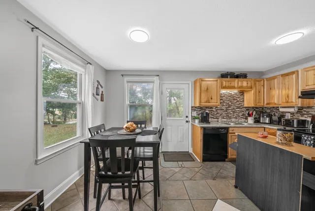 a kitchen with granite countertop lots of counter top space and dining table