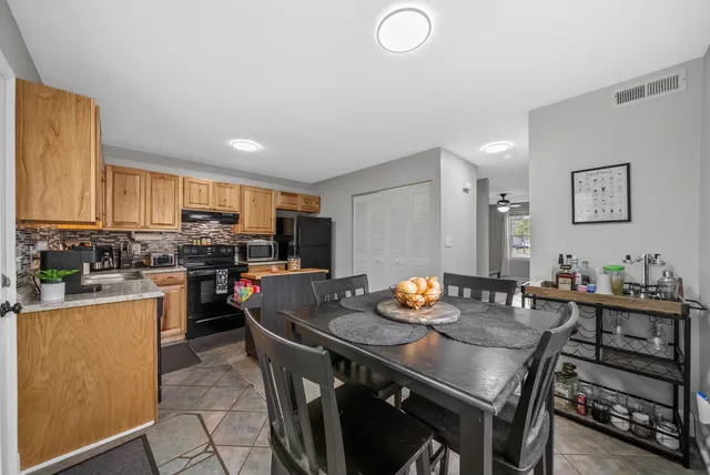a view of a dining room with furniture and window