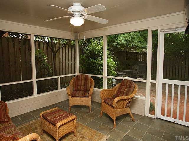1919 Sunset Drive Raleigh, NC 27608 - Photo 10 of 12 a living room with furniture and a floor to ceiling window