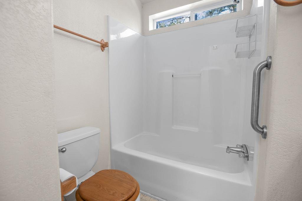 1281 Pleasant Valley Road, Unit 44 Diamond Springs, CA 95619 - Photo 15 of 27 a bathroom with a shower a toilet and a tub