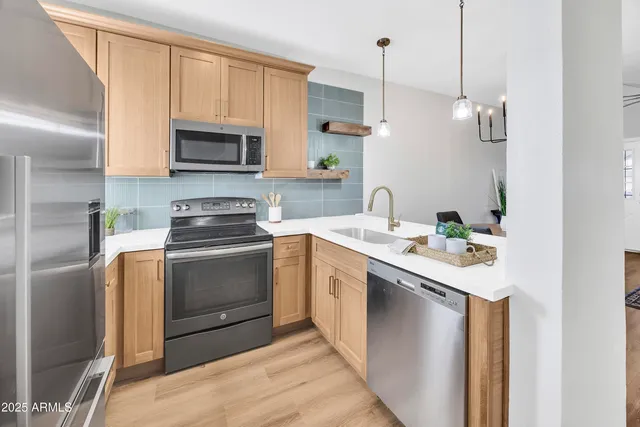 a kitchen with a sink stove and microwave