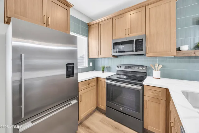 a kitchen with stainless steel appliances cabinets and a counter top space