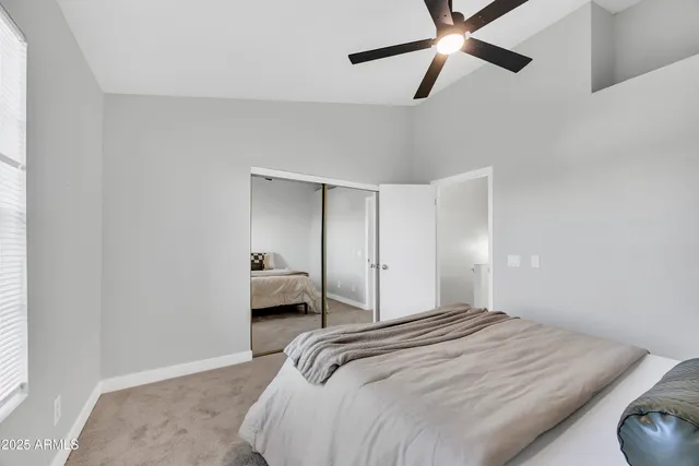 a bedroom with a bed and a window