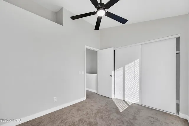 a view of a room with a ceiling fan