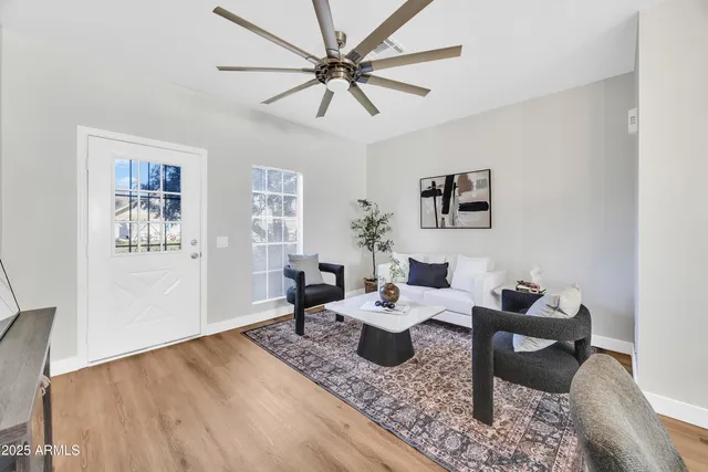 a living room with furniture and a wooden floor