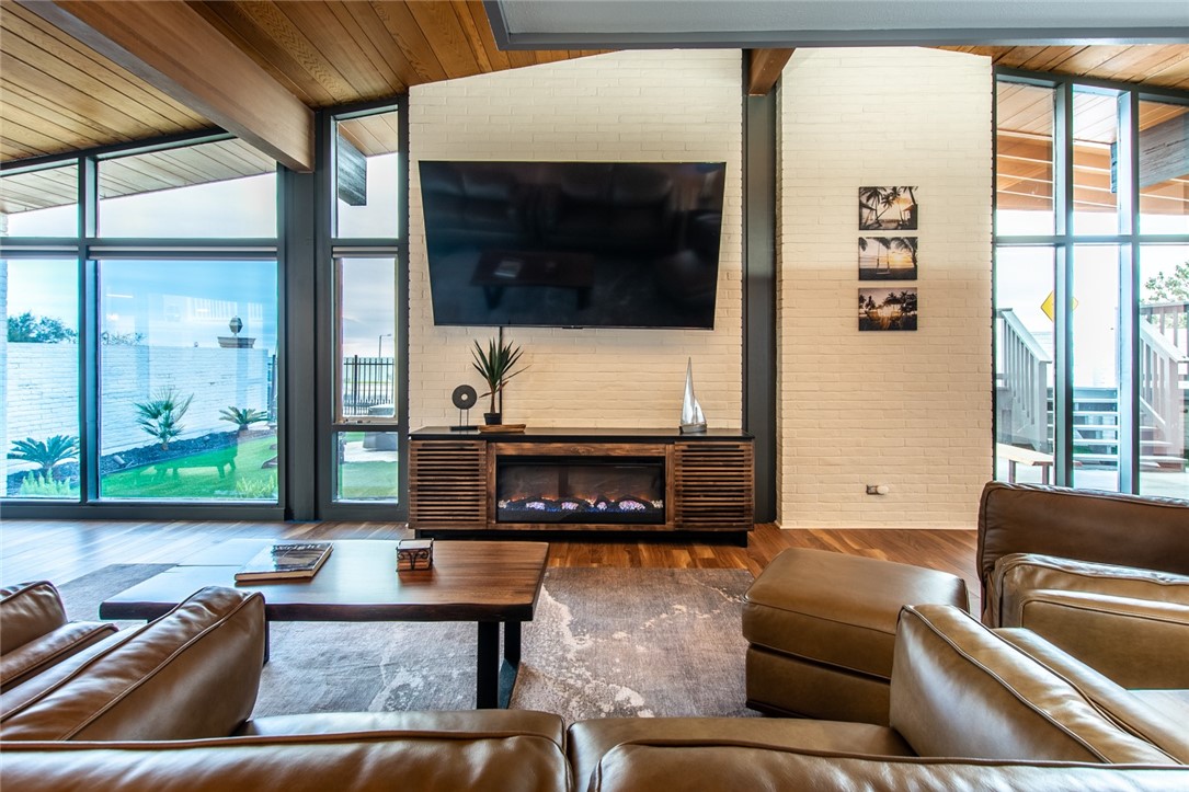 1617 Ocean Drive Corpus Christi, TX 78404 - Photo 13 of 40 a living room with furniture and a flat screen tv