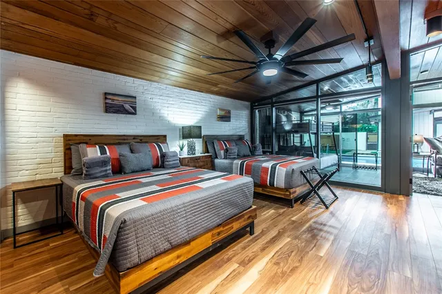 a bedroom with bed and wooden floor