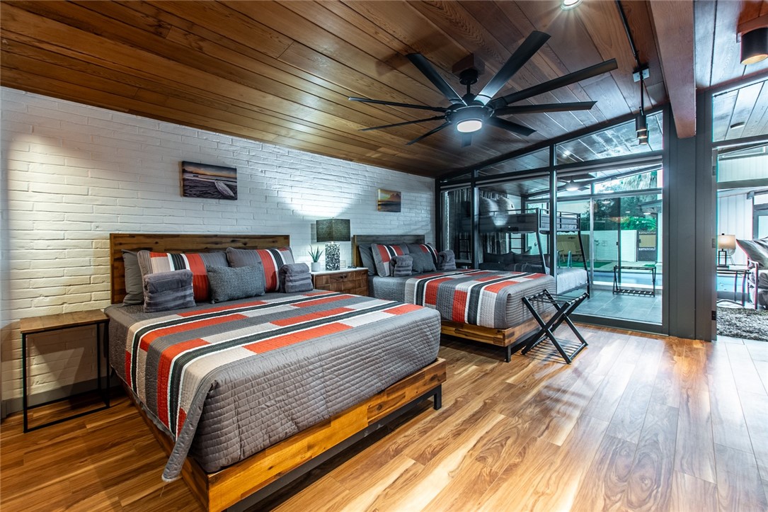 1617 Ocean Drive Corpus Christi, TX 78404 - Photo 16 of 40 a bedroom with bed and wooden floor