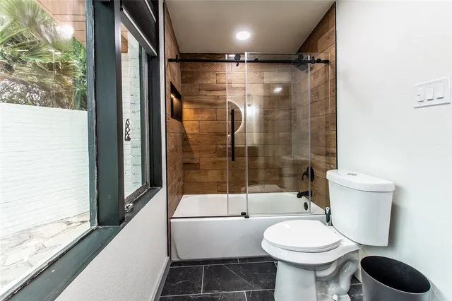 a bathroom with a toilet and a shower
