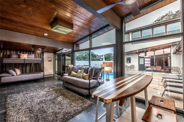 a living room with furniture a rug and a large window