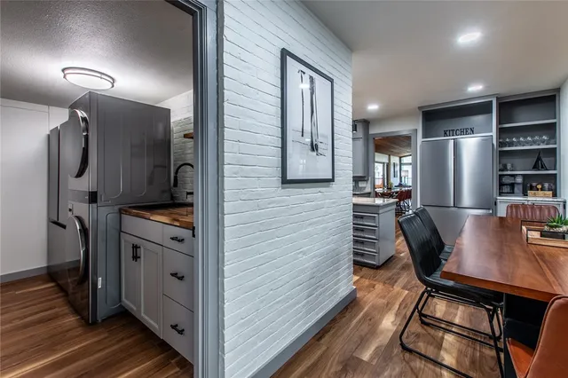 a view of kitchen with refrigerator stove and wooden floor