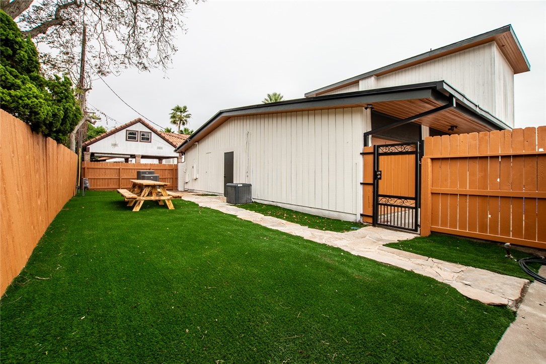 1617 Ocean Drive Corpus Christi, TX 78404 - Photo 30 of 40 a front view of a house with a yard and trees