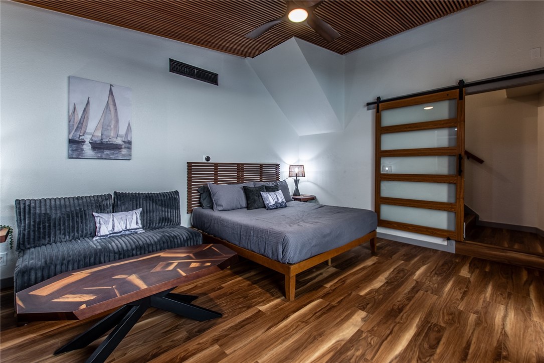 1617 Ocean Drive Corpus Christi, TX 78404 - Photo 32 of 40 a bedroom with a bed and wooden floor