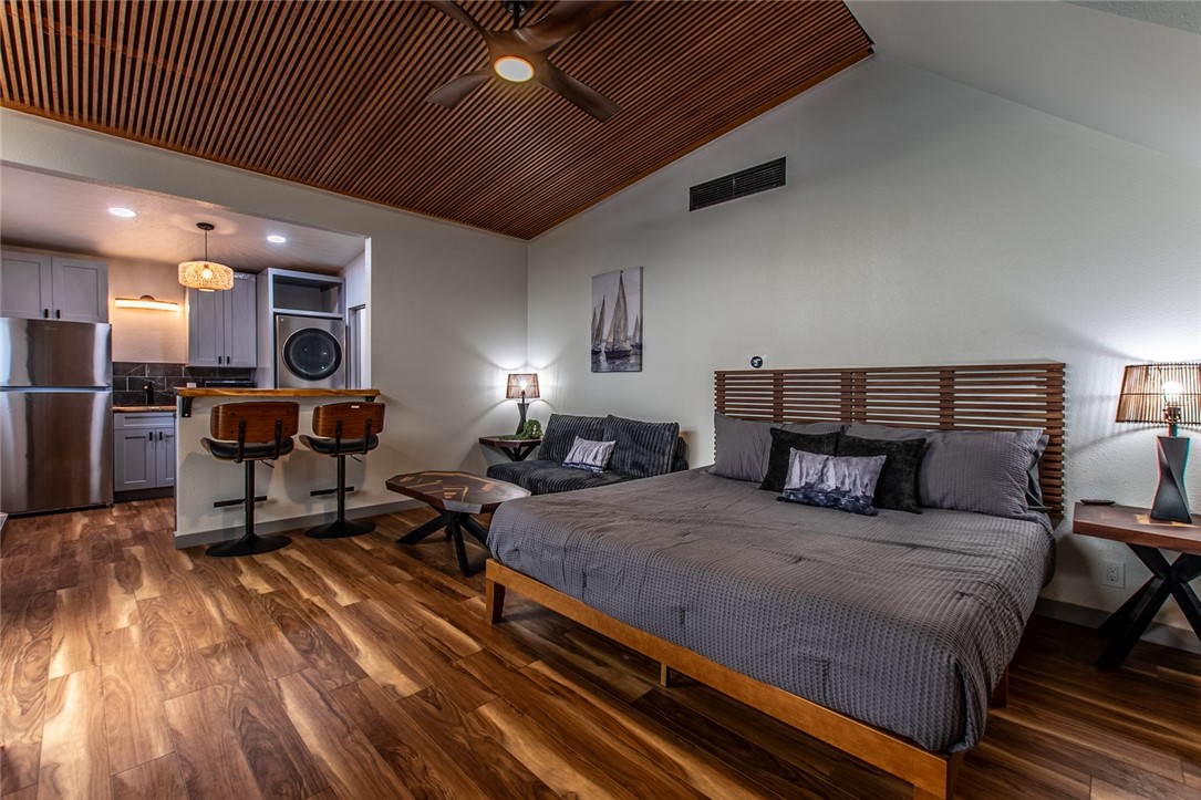 1617 Ocean Drive Corpus Christi, TX 78404 - Photo 33 of 40 a bedroom with a bed and a chandelier