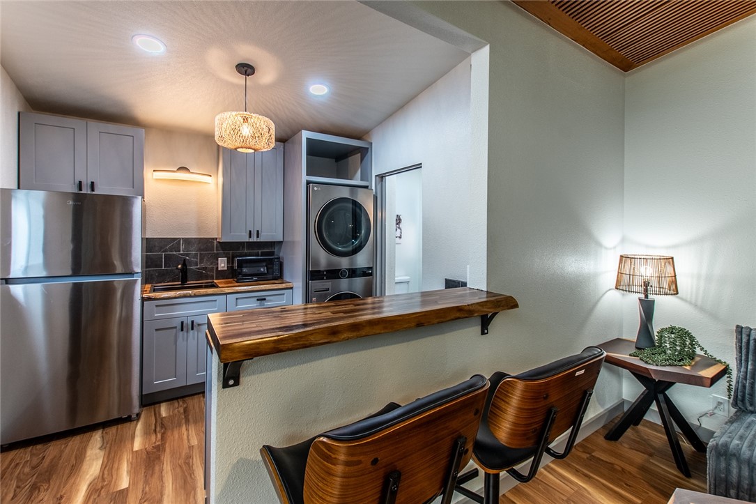 1617 Ocean Drive Corpus Christi, TX 78404 - Photo 34 of 40 a kitchen with stainless steel appliances granite countertop a stove refrigerator a microwave oven with cabinets and wooden floor