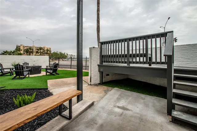 a porch with a bench next to yard