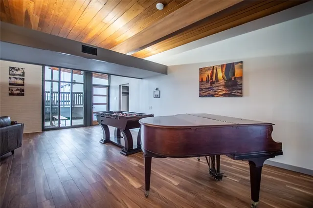 a view of a livingroom with furniture window and wooden floor