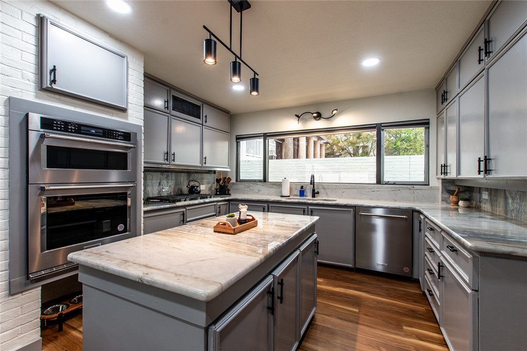 1617 Ocean Drive Corpus Christi, TX 78404 - Photo 7 of 40 a kitchen with a stove a sink and a microwave