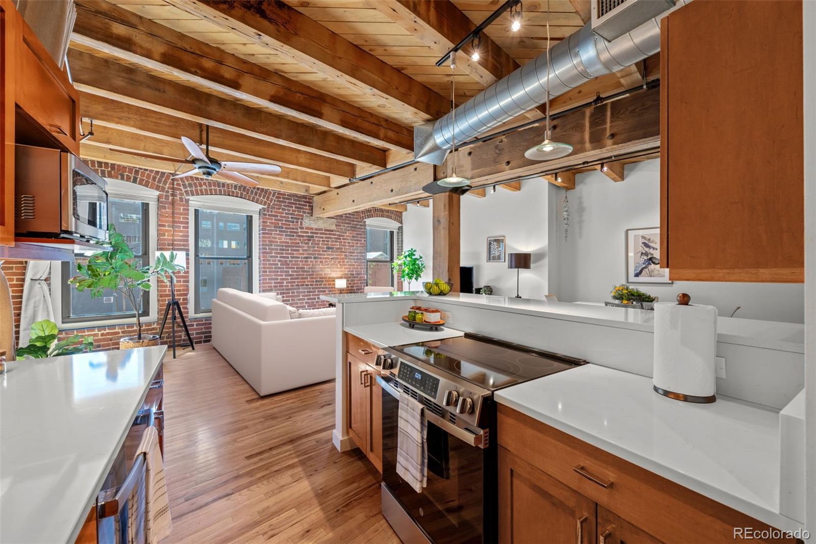 1745 Wazee Street, Unit 3C Denver, CO 80202 - Photo 14 of 23 a kitchen with a stove and a refrigerator