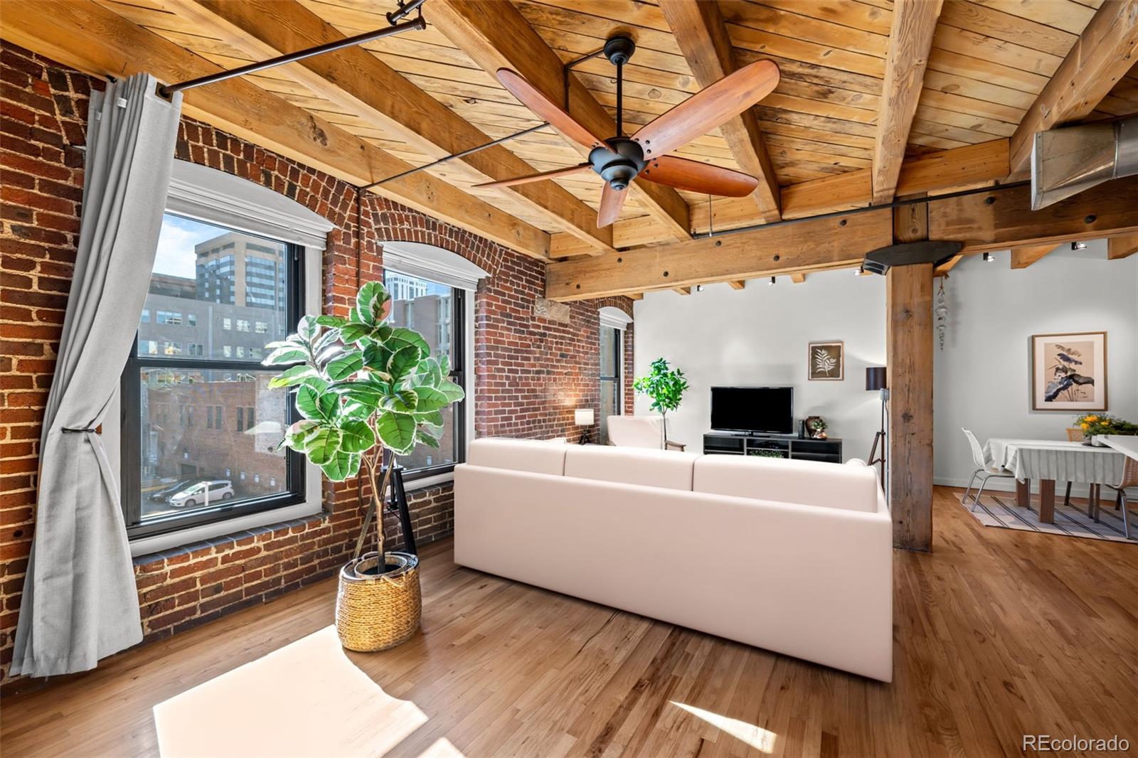 1745 Wazee Street, Unit 3C Denver, CO 80202 - Photo 17 of 23 a living room with furniture and a potted plant