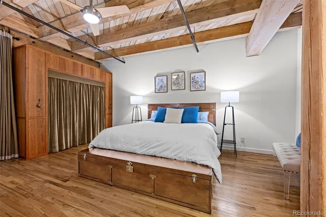 a bed sitting in a bedroom next to a window