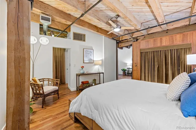 a bed room with a bed and a chair