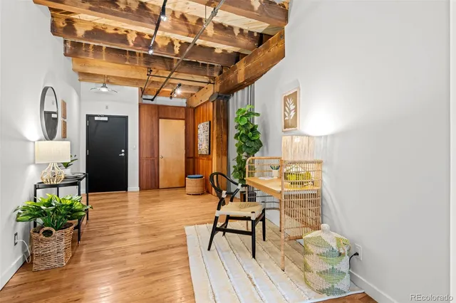 a view of a patio with table and chairs potted plants with wooden floor