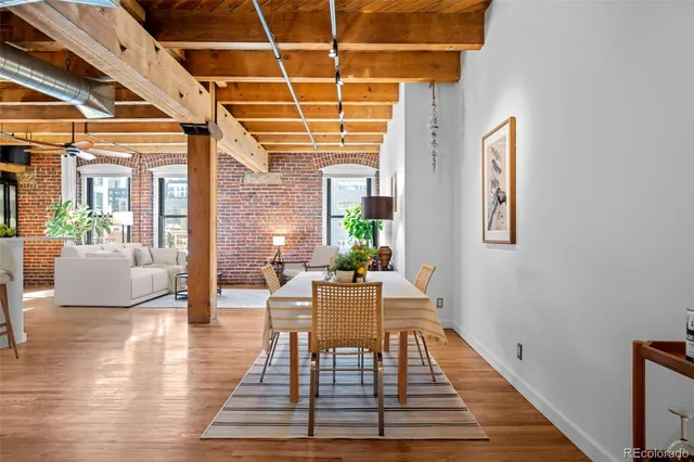 a dining room with wooden floor and a chandelier